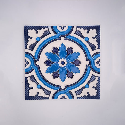 A square handcrafted Traditional Decor Wall Tile by Tejo Shop with an intricate blue and white floral pattern, centered on a white background. The design features symmetric floral motifs with a prominent bloom in the center.