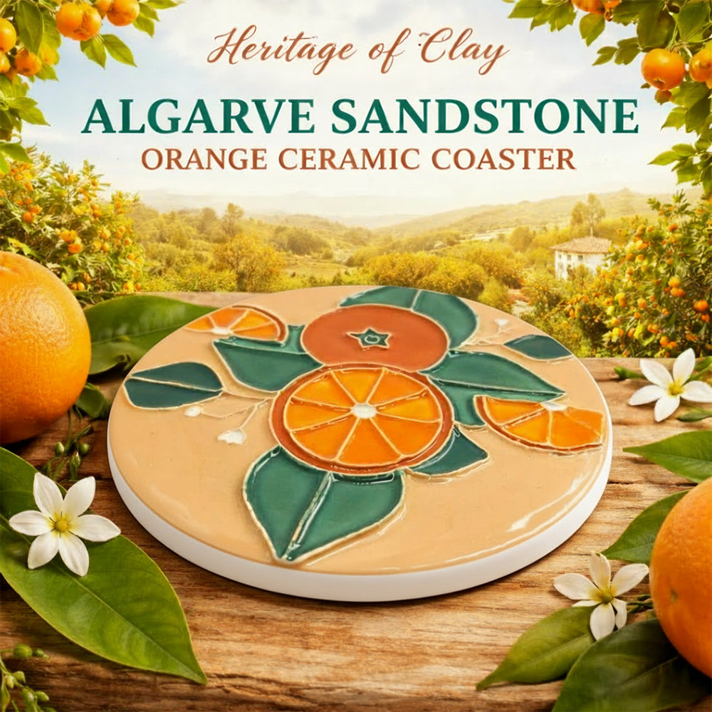 A Miradouro Ceramics Algarve Sandstone Orange Ceramic Coaster with an orange and green floral design is displayed among oranges, leaves, and white flowers with a scenic background and product name text.