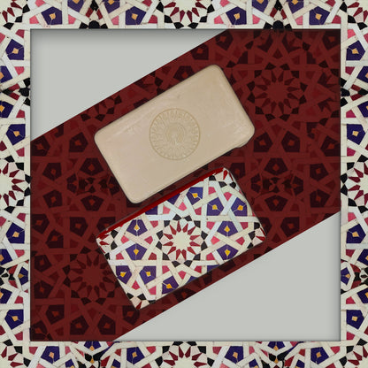 Ceuta 1415 – The First Horizon soap by 100ml, one beige with a circular pattern and another wrapped in multicolored geometric paper, are displayed on a red and white Islamic-style mosaic background.