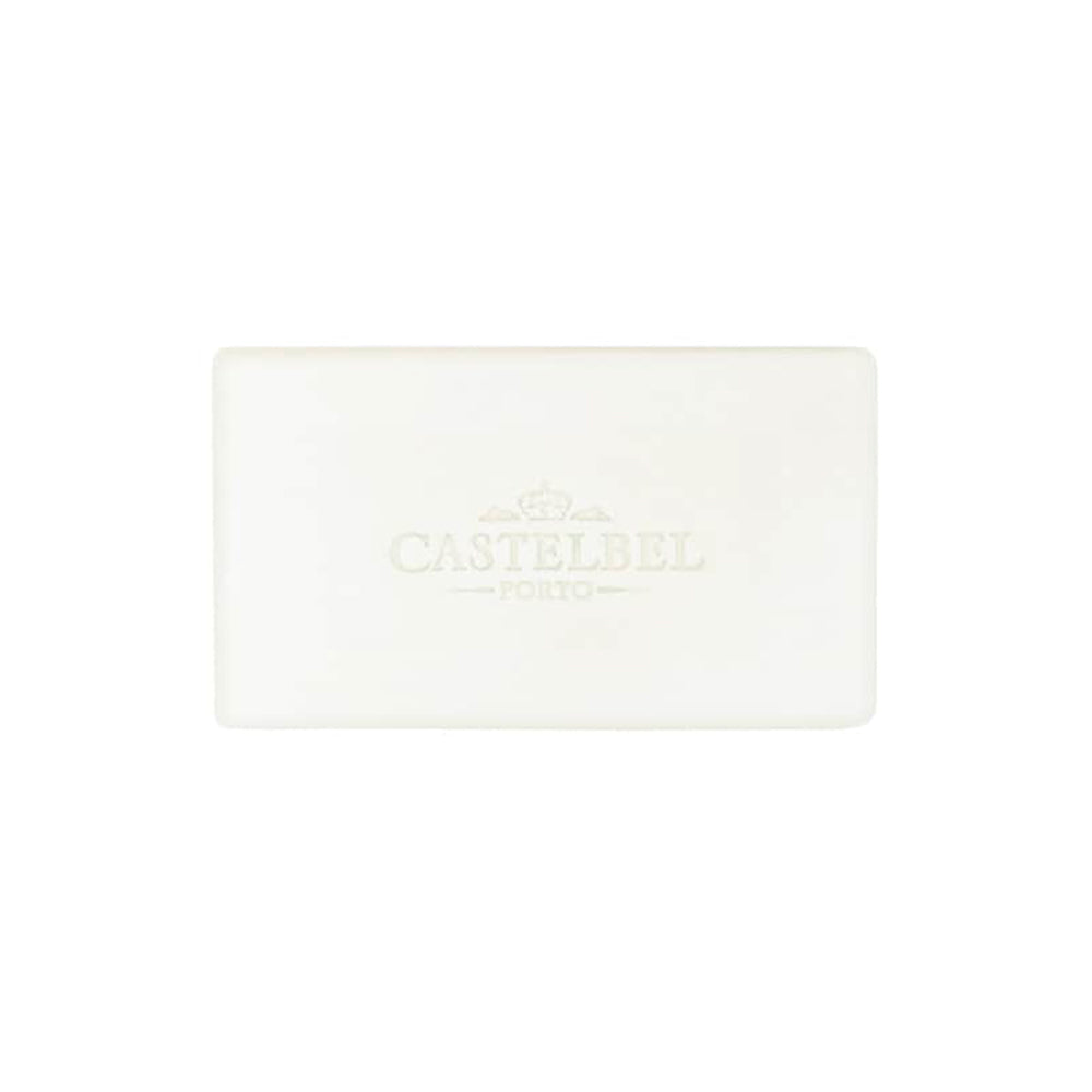 A plain white bar of Castelbel Milk Cream Soap 200g with the brand's logo embossed in the center, photographed against a white background, crafted to capture the essence of Portuguese culture.