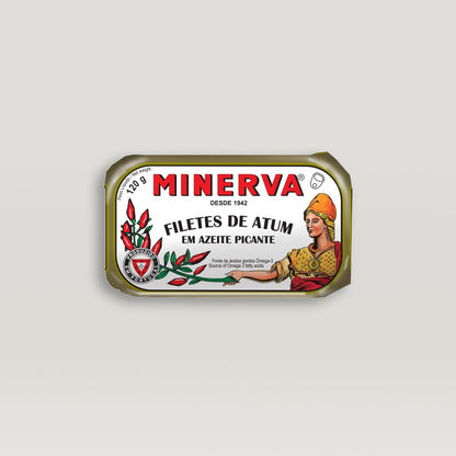 A can of Minerva tuna fillets in spiced olive oil with a woman in a hat.