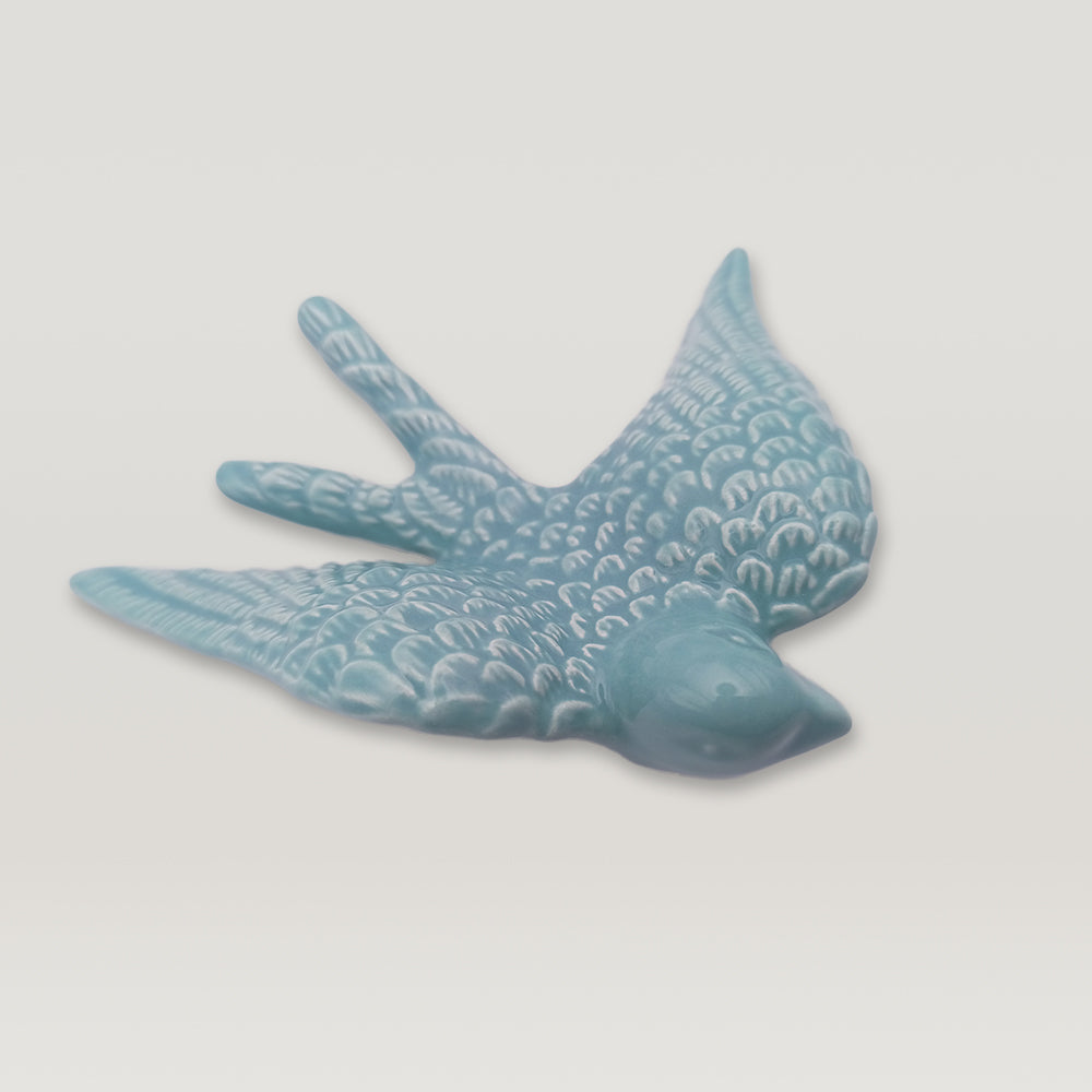 A Tejo Shop Portuguese Ceramic Swallow on a white surface.