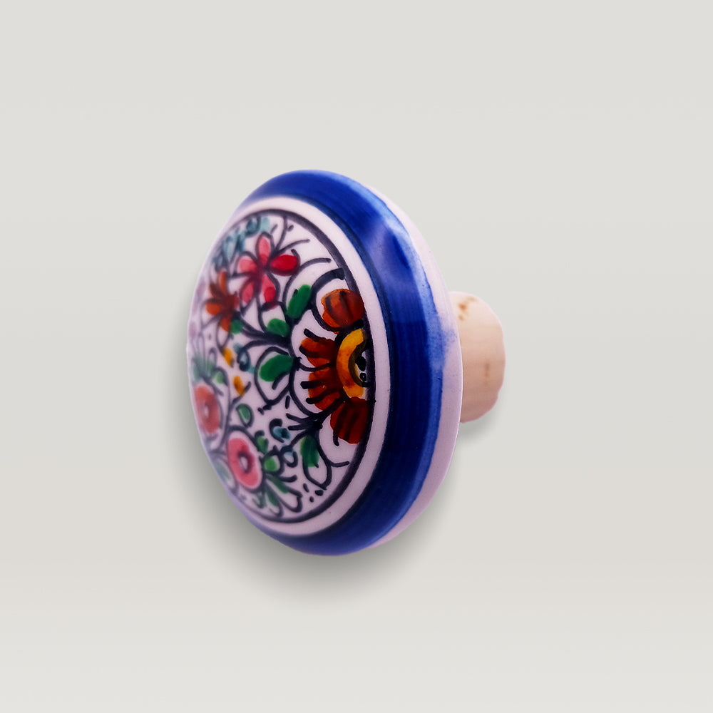 Hand painted ceramic XVII Century wine bottle stopper with floral design on a white background from Tejo Shop.