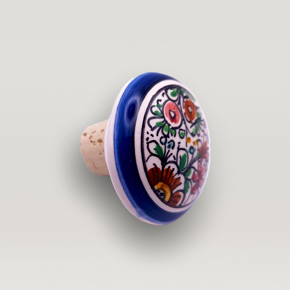 Hand-painted ceramic XVII Century Wine bottle stopper with floral pattern on a neutral background by Tejo Shop.