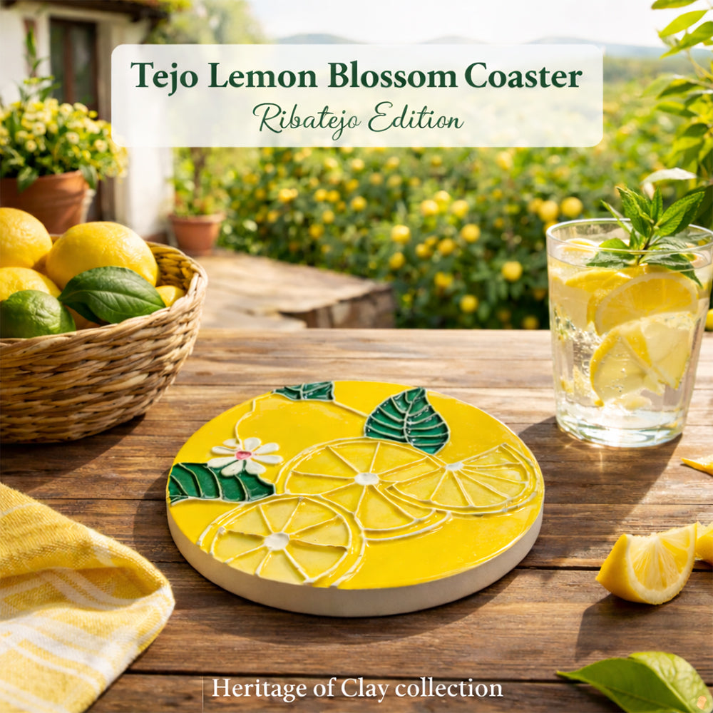 The Tejo Lemon Blossom Coaster – Ribatejo Edition by Miradouro Ceramics, featuring sliced lemons and a white flower, rests on a yellow tablecloth beside lemon water and fresh lemons, with “Tejo Lemon Blossom Coaster” text and a grove in the background.