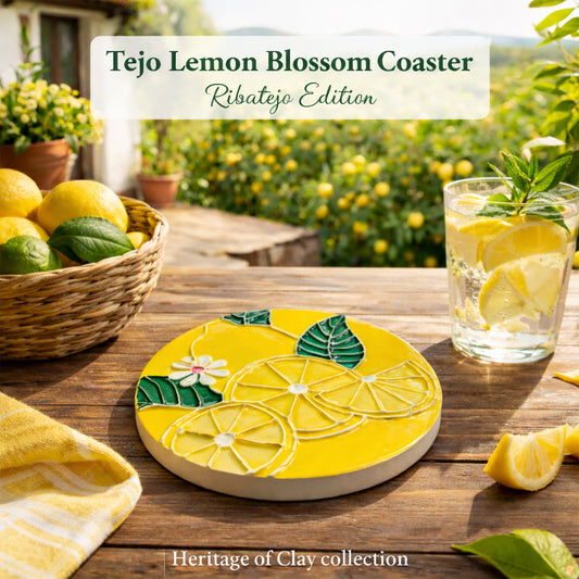 The Tejo Lemon Blossom Coaster – Ribatejo Edition by Miradouro Ceramics, featuring sliced lemons and a white flower, rests on a yellow tablecloth beside lemon water and fresh lemons, with “Tejo Lemon Blossom Coaster” text and a grove in the background.