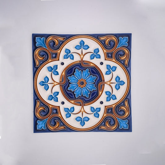 Decorative hand-painted ceramic tile featuring a symmetrical design with a central blue flower surrounded by blue and golden floral patterns on a white background from Tejo Shop's Royals Decor Blacksplash Tile.