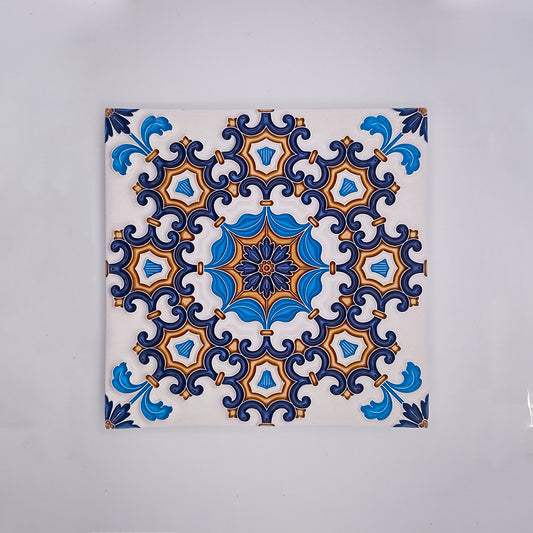 A decorative Tejo Shop Cascais Decor Tile with a symmetrical pattern featuring blue, white, and orange designs, centered around a star-like figure with intricate detailing.