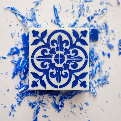 The Lisbão Amêndoa Royale Tile Soap Bar is a square, handcrafted soap featuring an intricate blue floral and geometric pattern on white, evoking Portuguese tile design and offering a delicate marzipan scent.