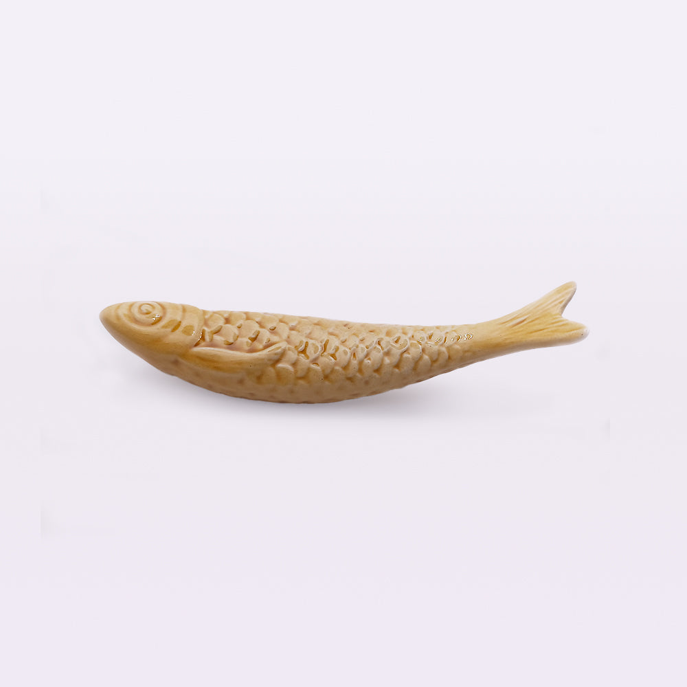 An intricately carved, fish-shaped wooden sculpture with detailed scales and fins showcases traditional craftsmanship. Positioned horizontally against a plain white background, this exquisite piece is perfect for home decor, reminiscent of Tejo Shop's Portuguese Ceramic Sardines.