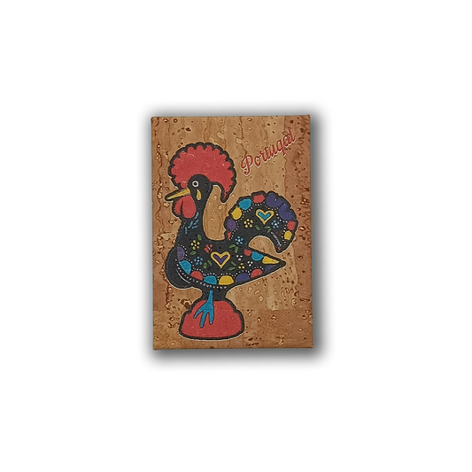 The Barcelos Rooster - Fridge Magnet by New Jamp features a colorful rooster with hearts and "Portugal" in red script. This eco-friendly cork magnet, edged in black with a red base, is a perfect souvenir of Portugal’s vibrant spirit.