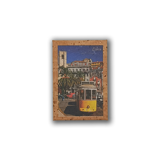A postcard-style image of a yellow tram on a Lisbon street, with palm trees and historic buildings under a blue sky, adorns the New Jamp "Lisbon Tram - Cork Fridge Magnet"—a perfect eco-friendly Portugal souvenir.