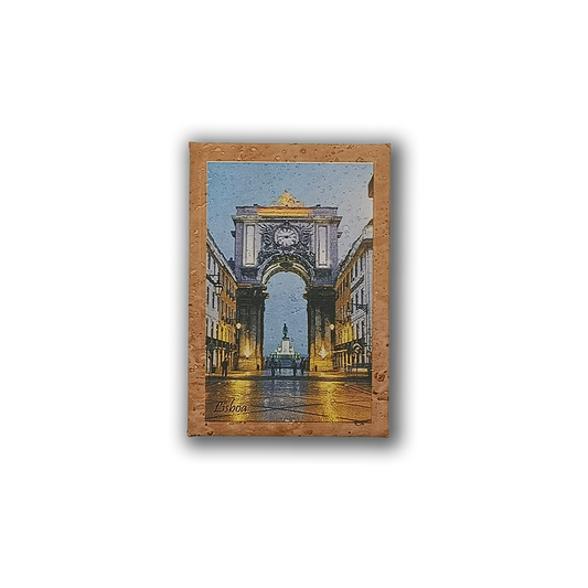 The New Jamp Rua Augusta Arch - Cork Fridge Magnet features Lisbon’s illuminated arch and wet streets at dusk, making it a unique souvenir or memento of your Lisbon tram adventure.