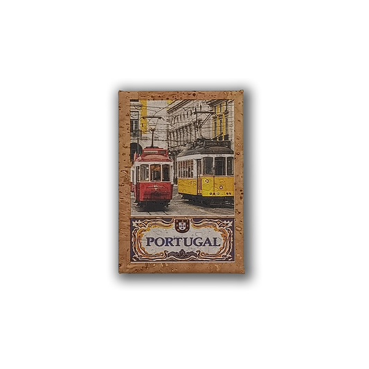A cork fridge magnet by New Jamp, "Trams Pair," featuring red and yellow trams on a Lisbon street with the Rua Augusta Arch in the background and “Portugal” in ornate lettering.