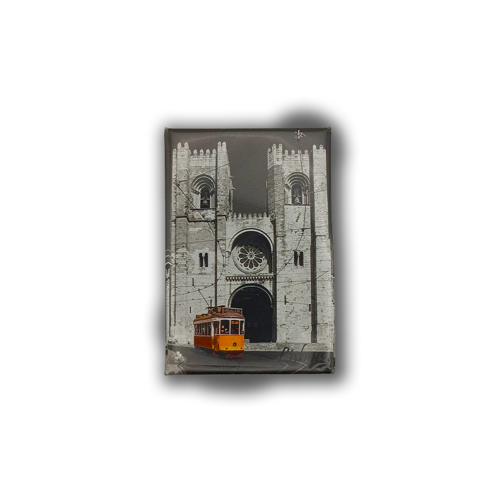 The New Jamp "Sé Patriarcal de Lisboa - Fridge Magnet" features a yellow Lisbon tram before the iconic twin-towered Lisbon Cathedral, set against a black and white backdrop—a perfect city keepsake.