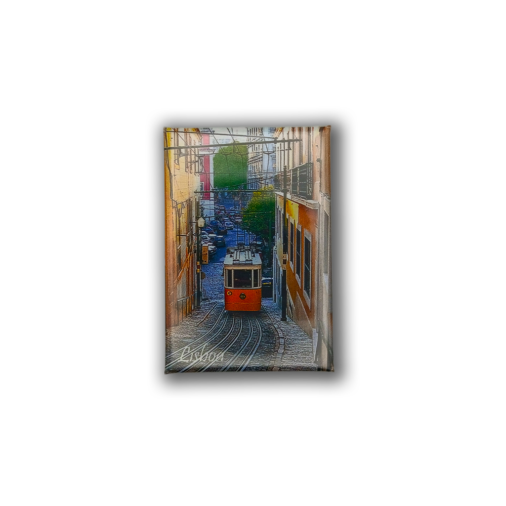 The Lisbon Tram - Fridge Magnet by New Jamp features a red tram going uphill between vibrant buildings in a narrow Lisbon street with greenery, and "Lisbon" written at the corner—making it a charming souvenir.