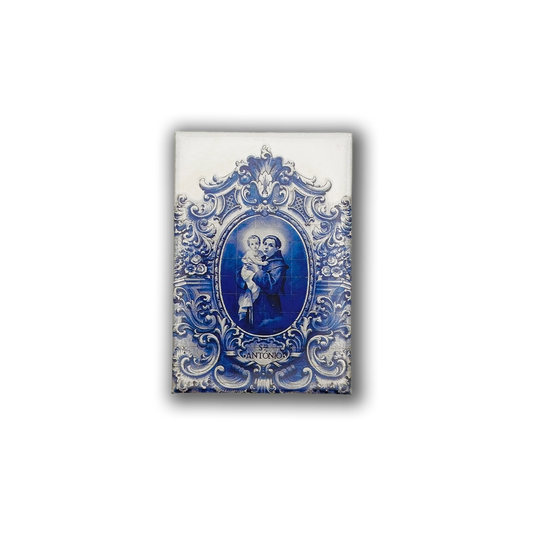 The Saint Antonio - Fridge Magnet by New Jamp features a blue and white ornate ceramic tile design, depicting Saint Anthony holding a child, with "SANTONIO" inscribed—an elegant tribute to Lisbon’s heritage.