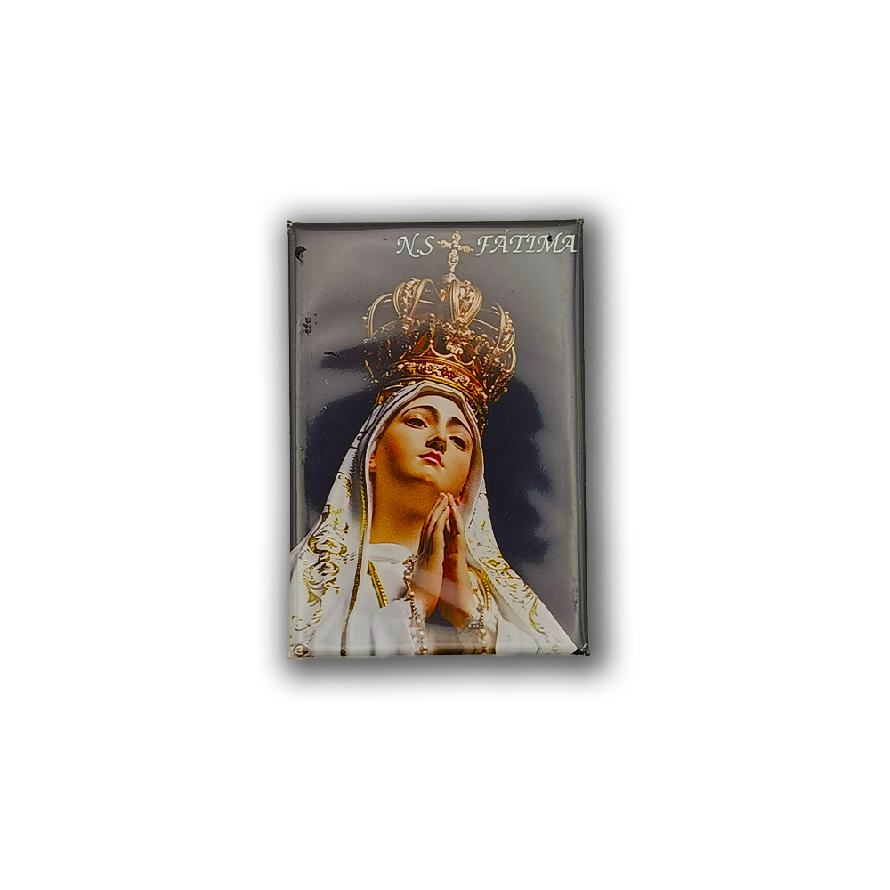 The New Jamp Our Lady of Fatima - Fridge Magnet features a crowned figure in white robes, hands clasped in prayer, with "N.S. FATIMA" at the top right against a dark background—a perfect Lisbon souvenir.