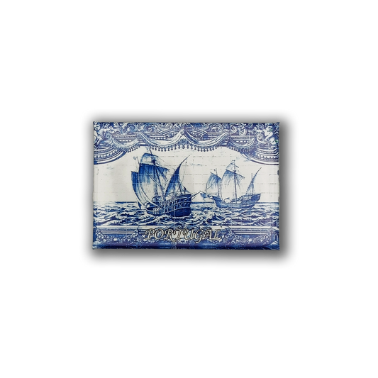 The New Jamp "Discoveries Tile" fridge magnet features blue and white sailing ships, ornate borders, and "PORTUGAL" text—a charming Lisbon keepsake inspired by the Tower of Belém.