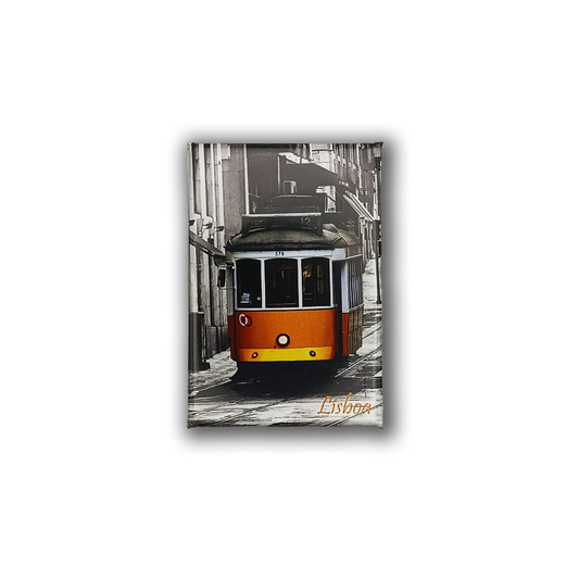 The Lisbon Tram - Fridge Magnet by New Jamp features a yellow and white tram on a cobblestone street in Lisbon. The black and white background highlights the vibrant tram. “Lisboa” is printed in orange at the bottom right—ideal fridge decor.