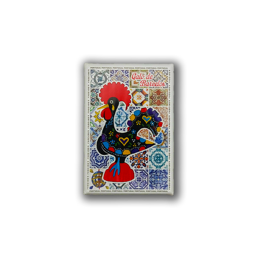 The New Jamp Barcelos Rooster Fridge Magnet showcases the colorful Galo de Barcelos with heart and flower motifs on a blue-and-white tile background, celebrating Portugal's artistic heritage.