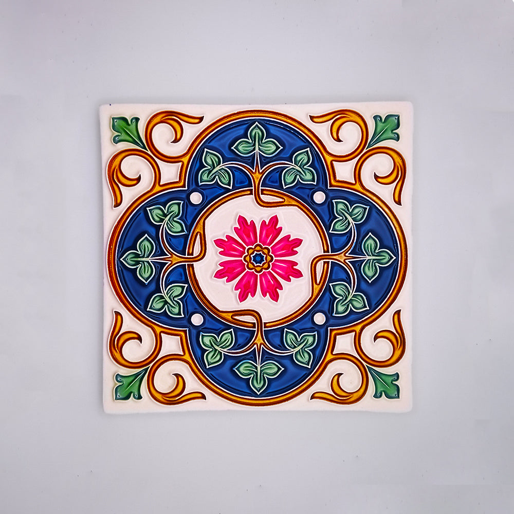 Colorful hand-painted Tejo Shop Mediterranean Kitchen Tile with a symmetrical floral design in vibrant blue, pink, green, and yellow, set against a white background.