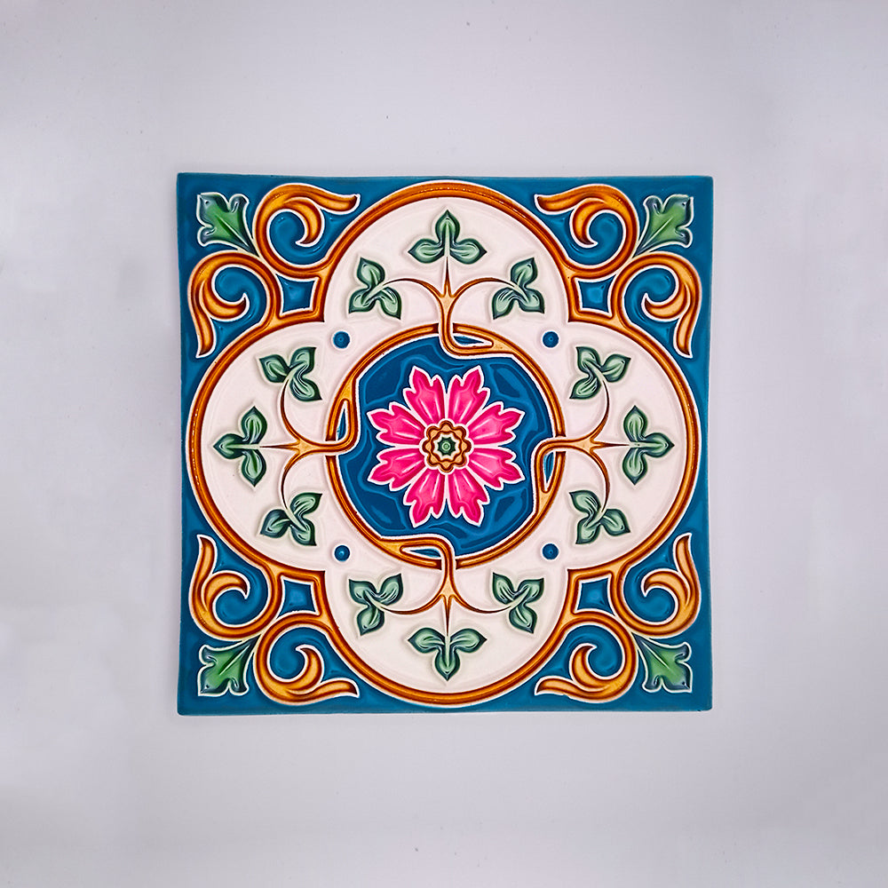 Decorative hand-painted Mediterranean Style Tile from Tejo Shop featuring a colorful floral design with a pink flower at the center surrounded by green, blue, and orange patterns, set against a white background.