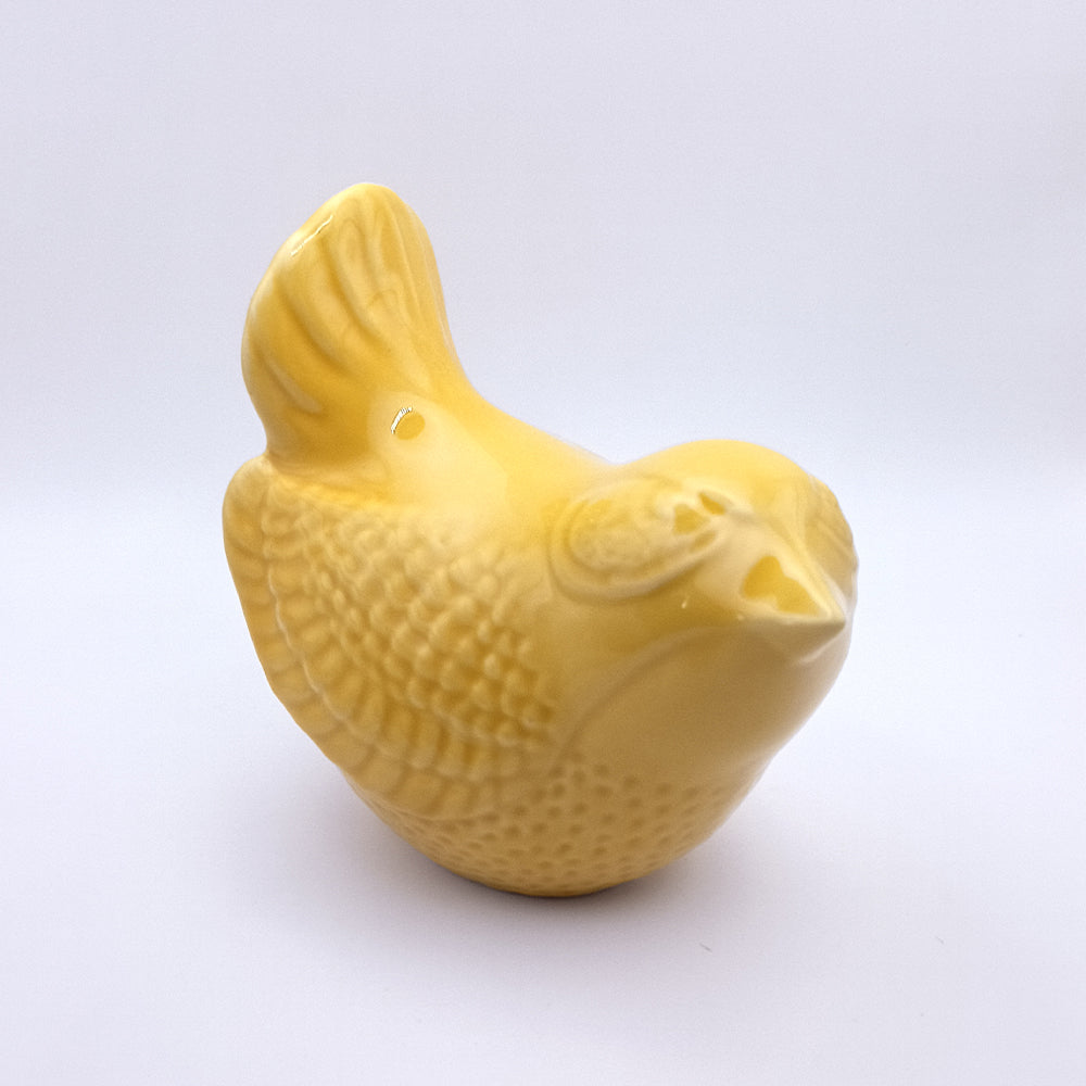 Add a touch of handmade charm to your home decor with the Tejo Shop Ceramic Bird Figurine, a small yellow bird with textured wings and tail, sitting upright on a plain white background.